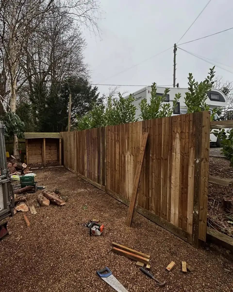 Completed timber closeboard fence line installed along a garden boundary.