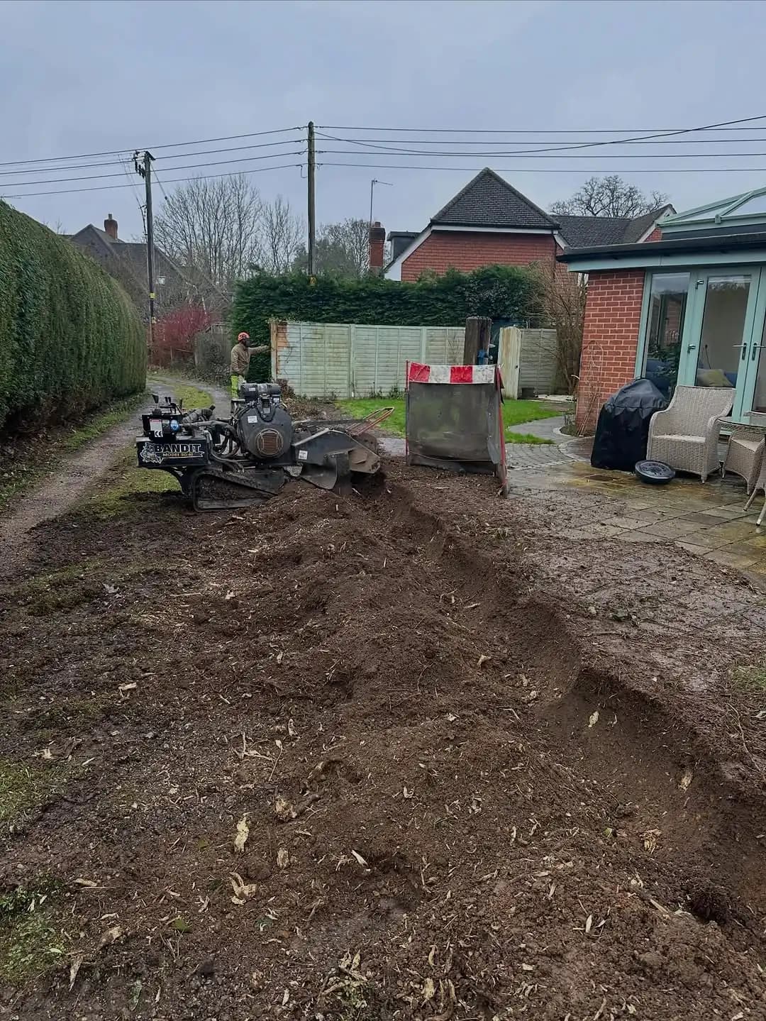 Stump grinding machine removing a tree stump below ground level